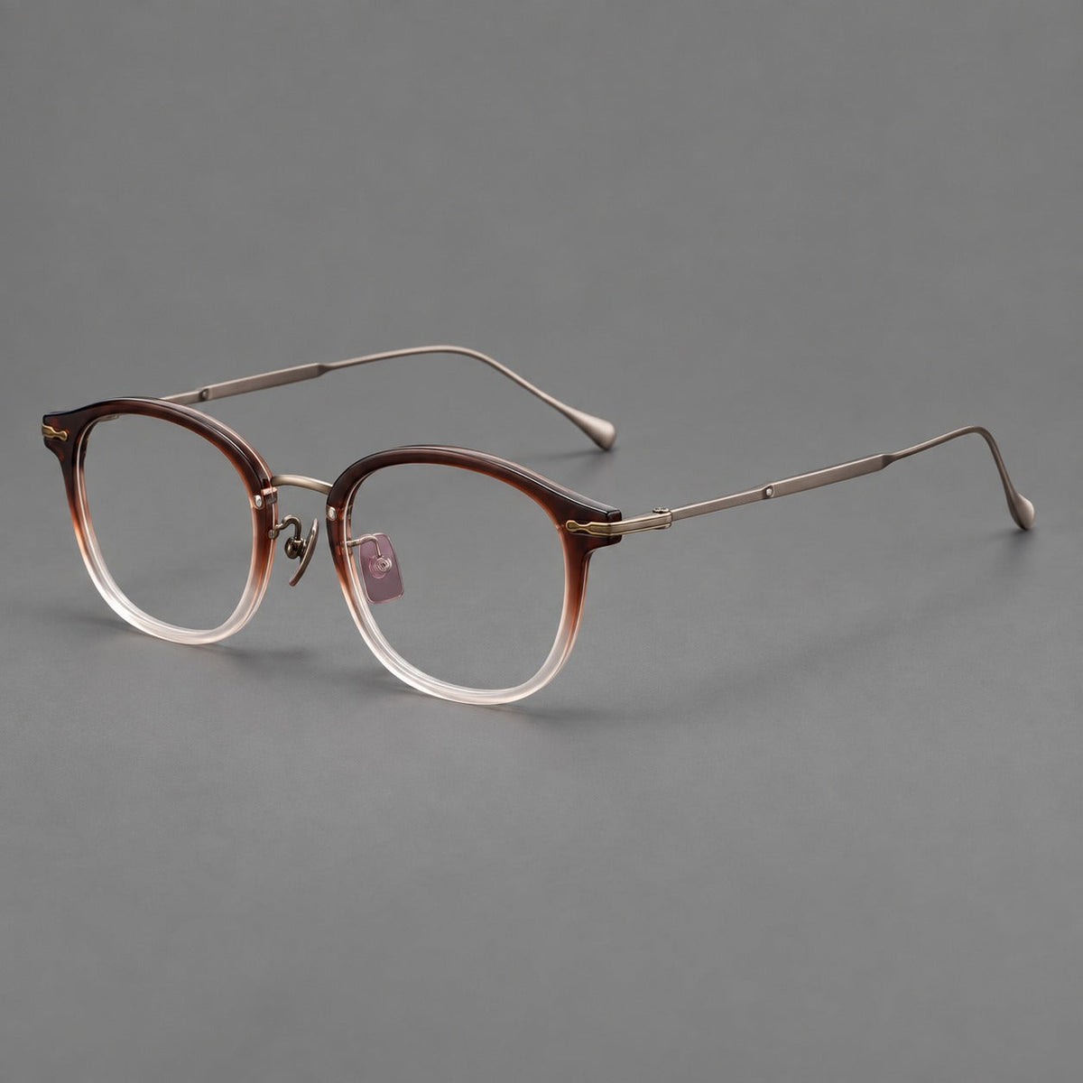 Panto eyeglasses in acetate and titanium with curved brows and decorative metal corner accents in Tea Brown Gradient / Antique Bronze, three quarter view