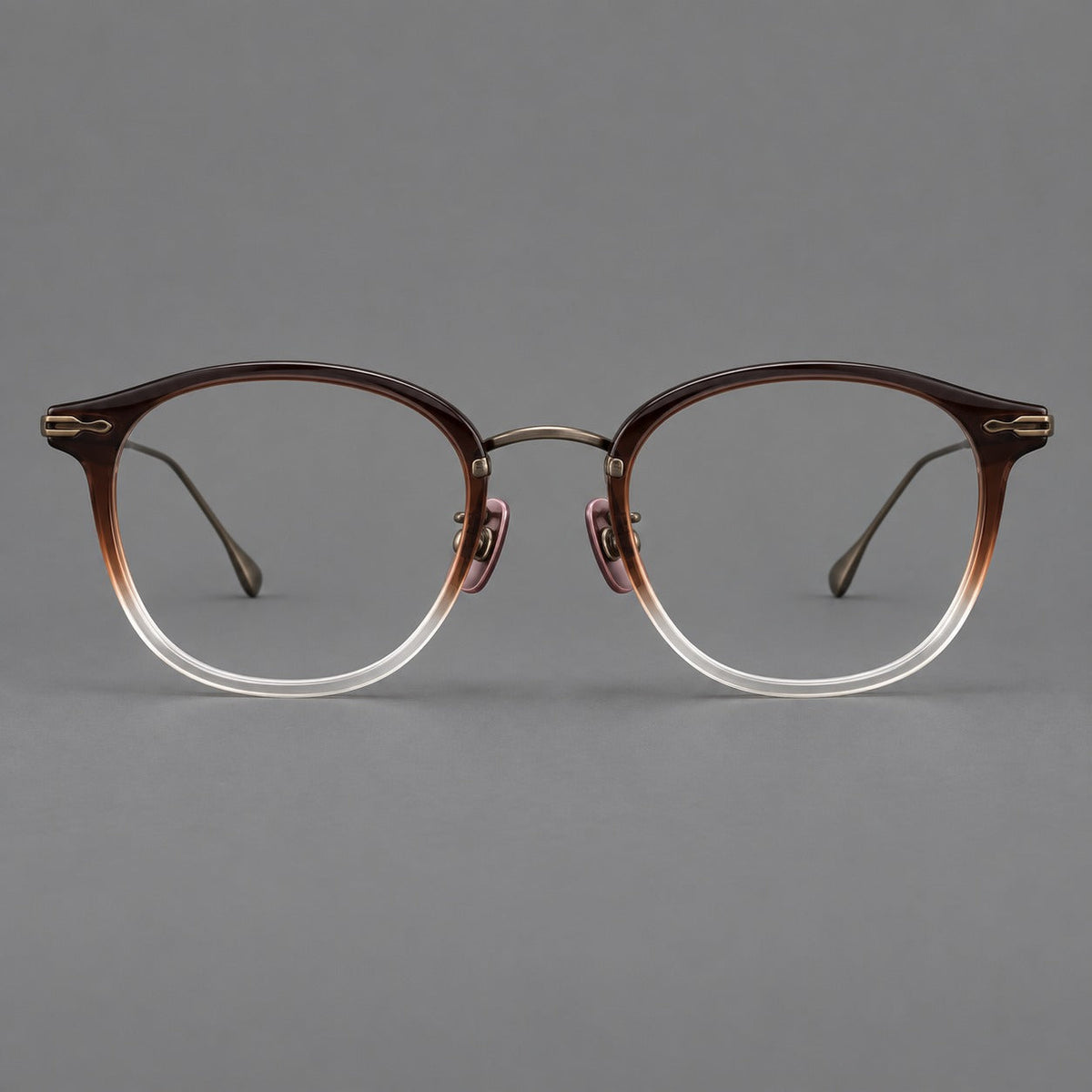 Panto eyeglasses in acetate and titanium with curved brows and decorative metal corner accents in Tea Brown Gradient / Antique Bronze, front view