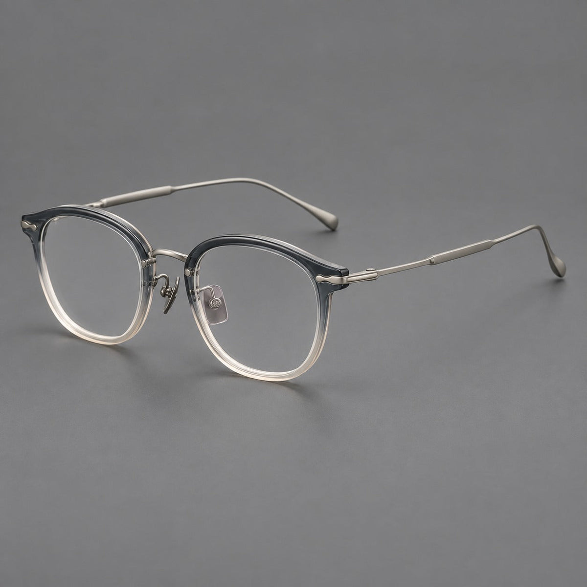 Panto eyeglasses in acetate and titanium with curved brows and decorative metal corner accents in Ice Blue Tea / Silver, three quarter view