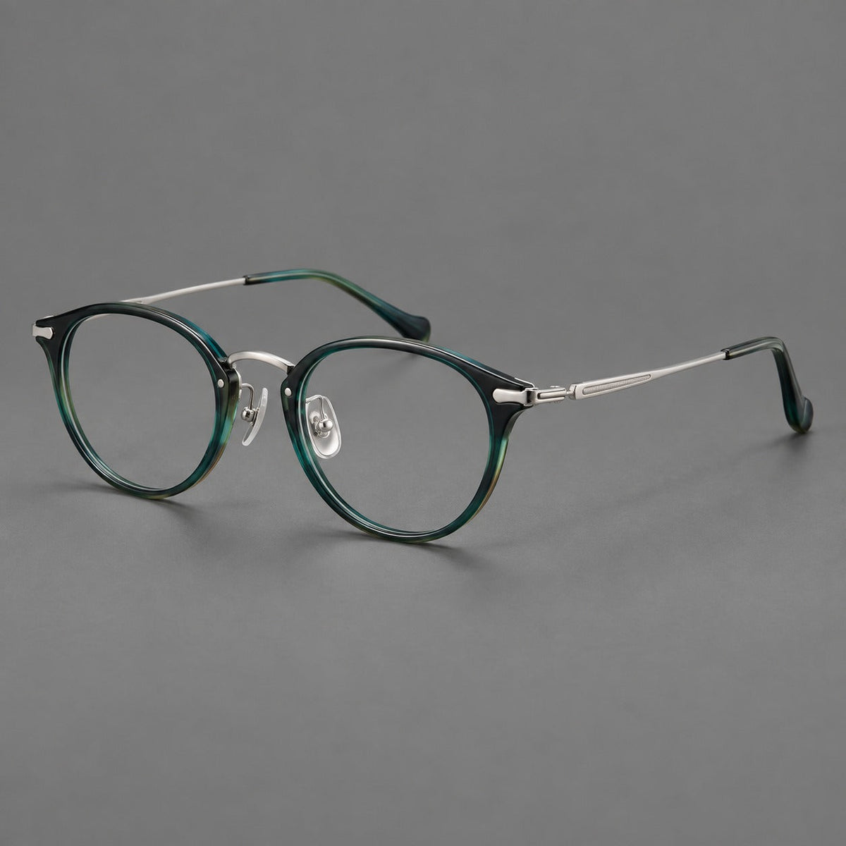 Vintage panto eyeglasses in acetate and titanium with raised brows and textured metal temples in Peacock Blue / Silver, three quarter view