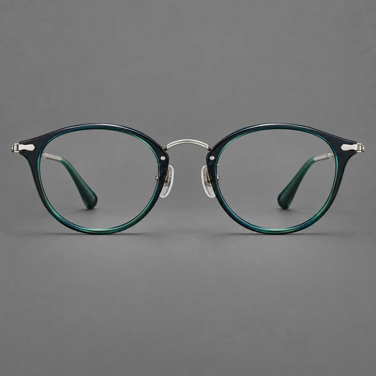 Vintage panto eyeglasses in acetate and titanium with raised brows and textured metal temples in Peacock Blue / Silver, front view