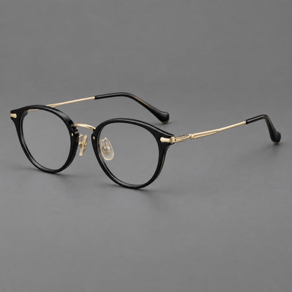Vintage panto eyeglasses in acetate and titanium with raised brows and textured metal temples in Glossy Black / Gold, three quarter view lens detail