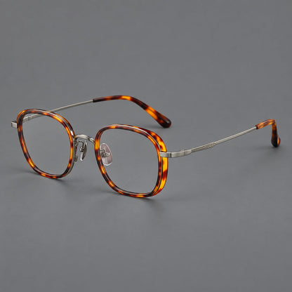 Rounded square eyeglasses in acetate and titanium with an arched bridge and engraved temples in Amber Tortoiseshell / Gunmetal, three quarter view
