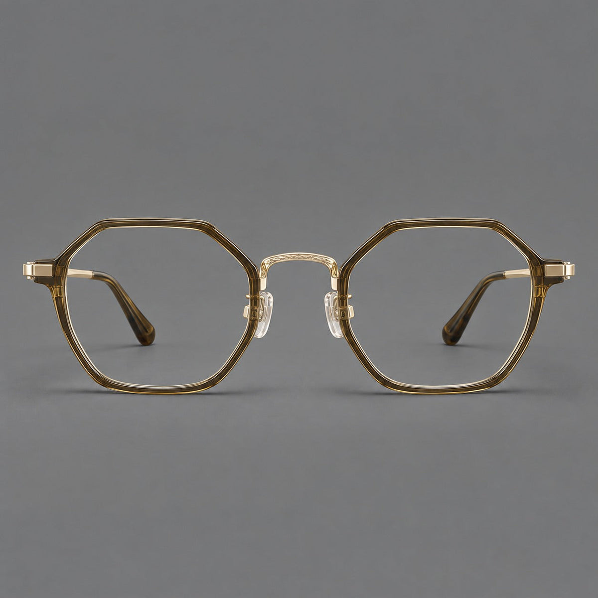 Geometric eyeglasses in acetate and titanium with octagonal rims and a textured metal bridge in Clear Tea Green / Light Gold, front view