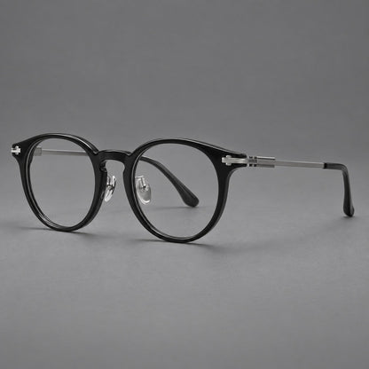 Retro acetate and titanium eyeglasses with round rims and a pronounced keyhole bridge in Black / Gray, three quarter view front view