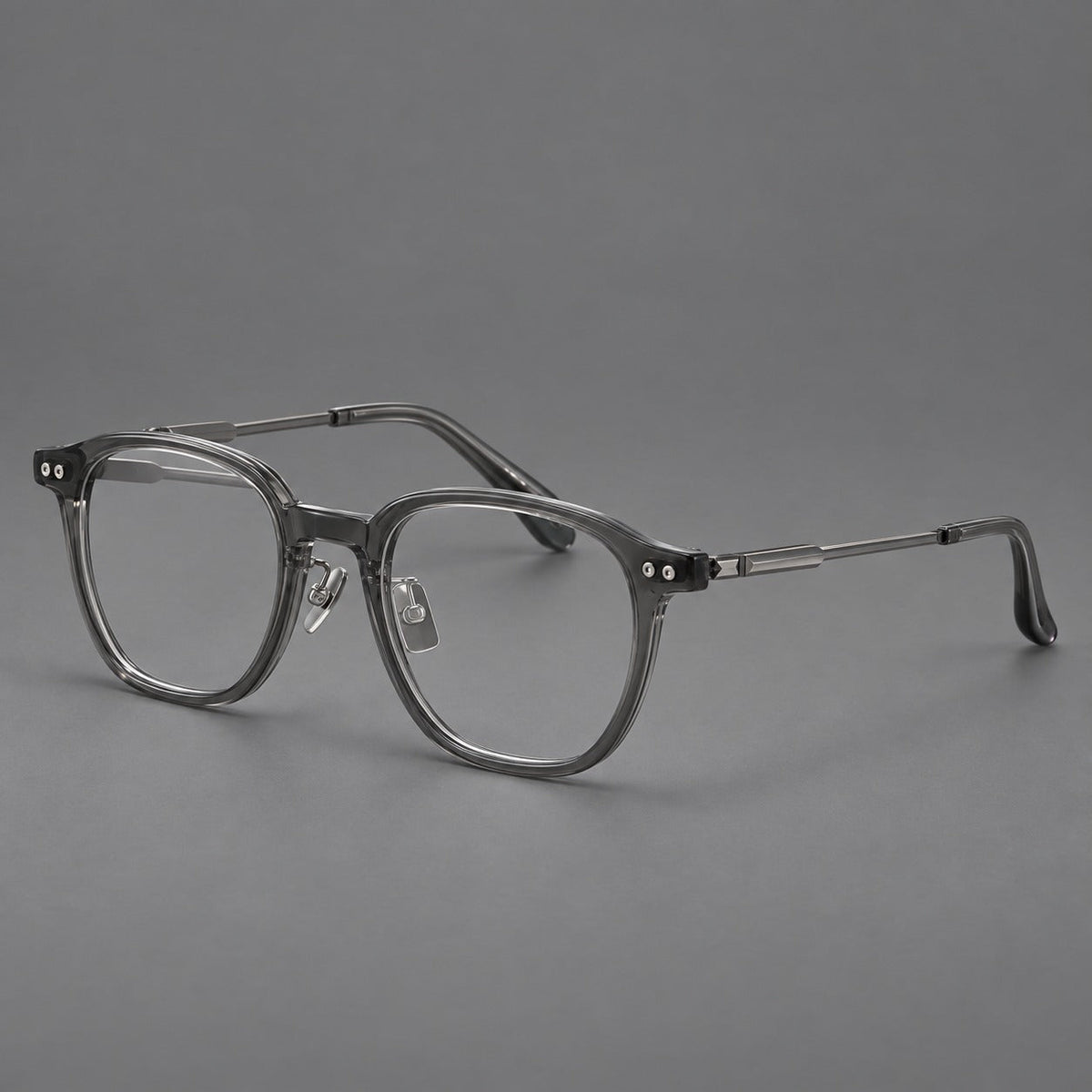 Vintage acetate and titanium eyeglasses with rounded square rims and slotted metal temples in Clear Gray, three quarter view