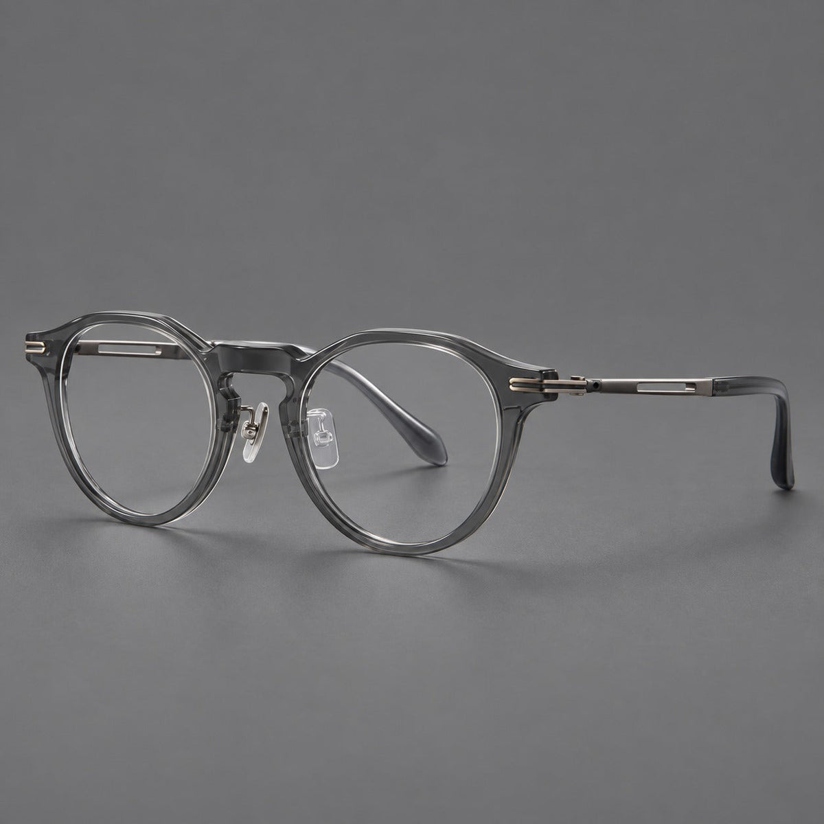 Retro acetate and titanium eyeglasses with round rims and distinctive looped metal joints in Clear Gray / Brushed Gray, three quarter view