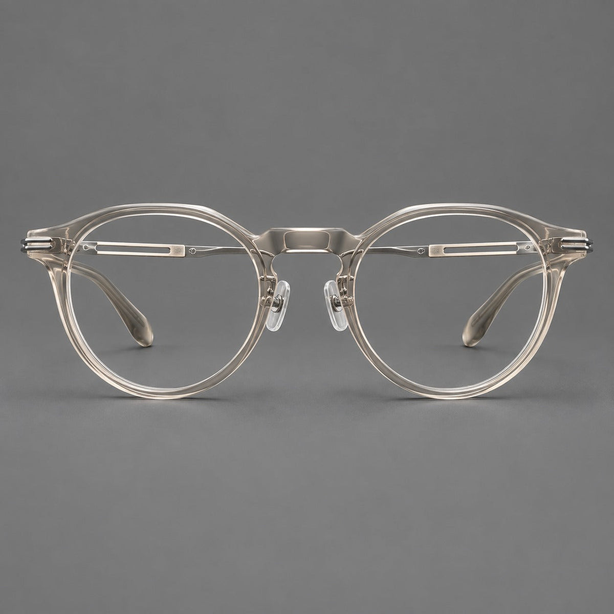 Retro acetate and titanium eyeglasses with round rims and distinctive looped metal joints in Clear Cool Tea / Silver, front view