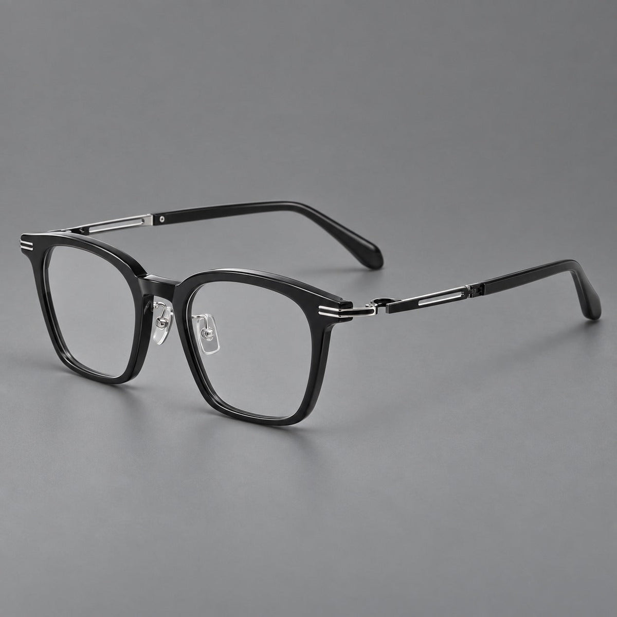 Acetate and titanium eyeglasses with rounded rectangular rims and sculpted open loop joints in Black / Silver, three quarter view