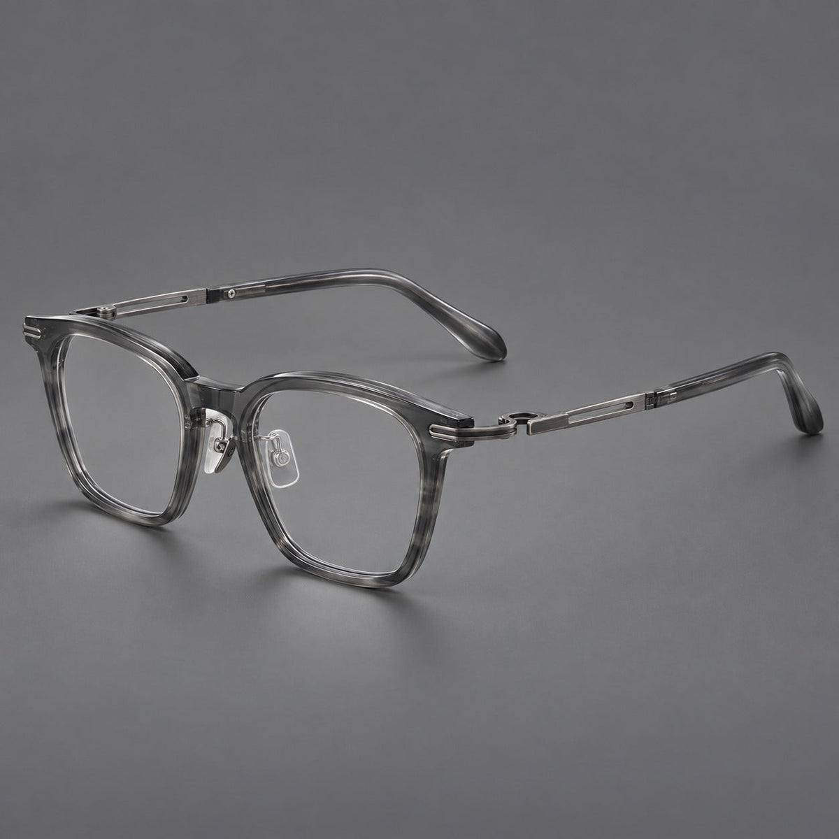 Acetate and titanium eyeglasses with rounded rectangular rims and sculpted open loop joints in Clear Gray / Brushed Gray, three quarter view