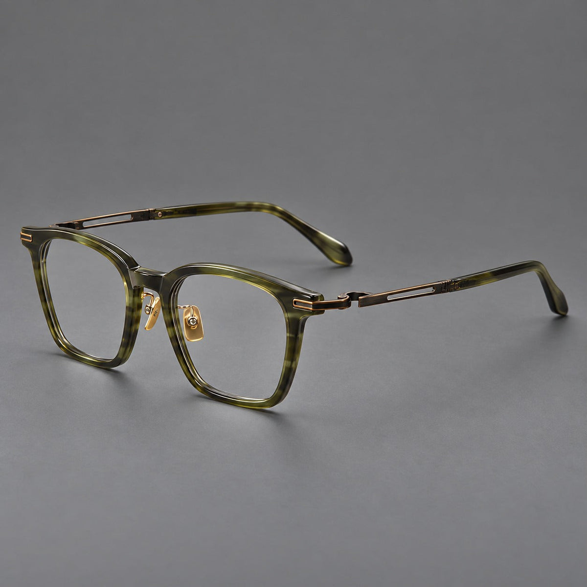 Acetate and titanium eyeglasses with rounded rectangular rims and sculpted open loop joints in Clear Olive Green / Antique Bronze, three quarter view