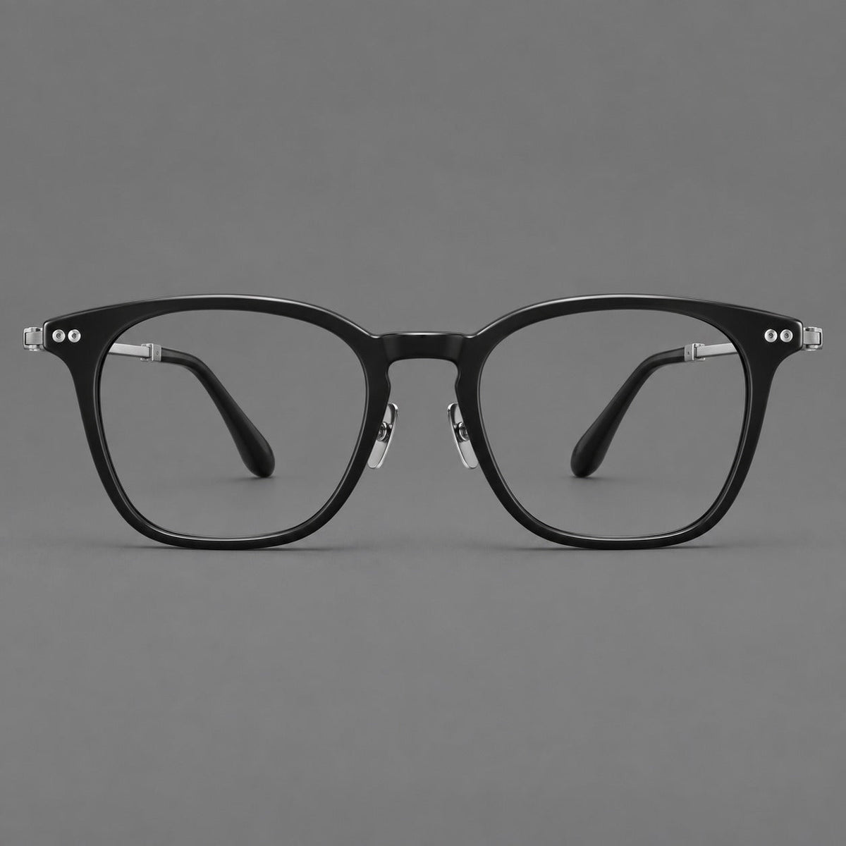 Retro acetate and titanium eyeglasses with gently squared rims and circular metal hinges in Black / Silver, front view