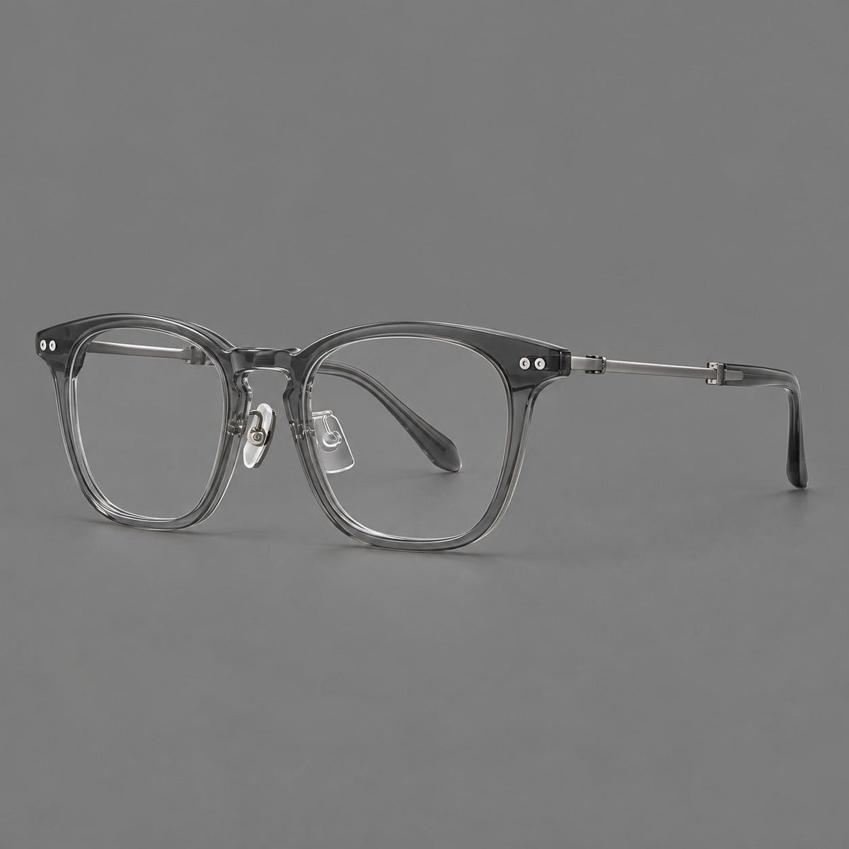 Retro acetate and titanium eyeglasses with gently squared rims and circular metal hinges in Clear Gray / Brushed Gray, three quarter view