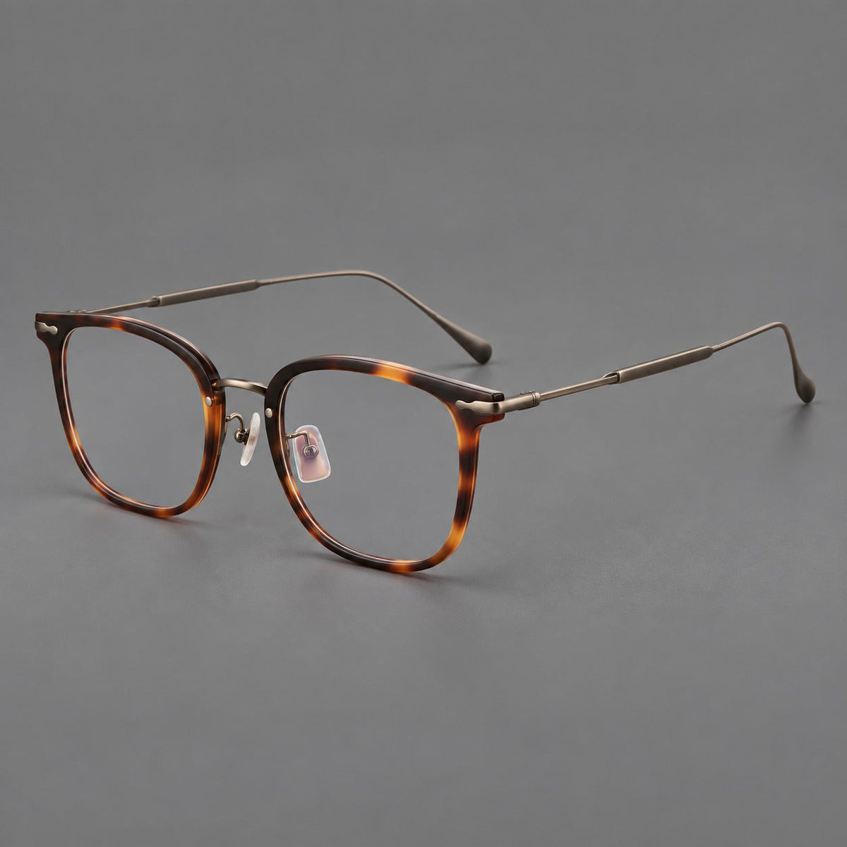 Retro square eyeglasses in acetate and titanium with rounded edges and sculpted corner accents in Tortoiseshell / Antique Copper, three quarter view