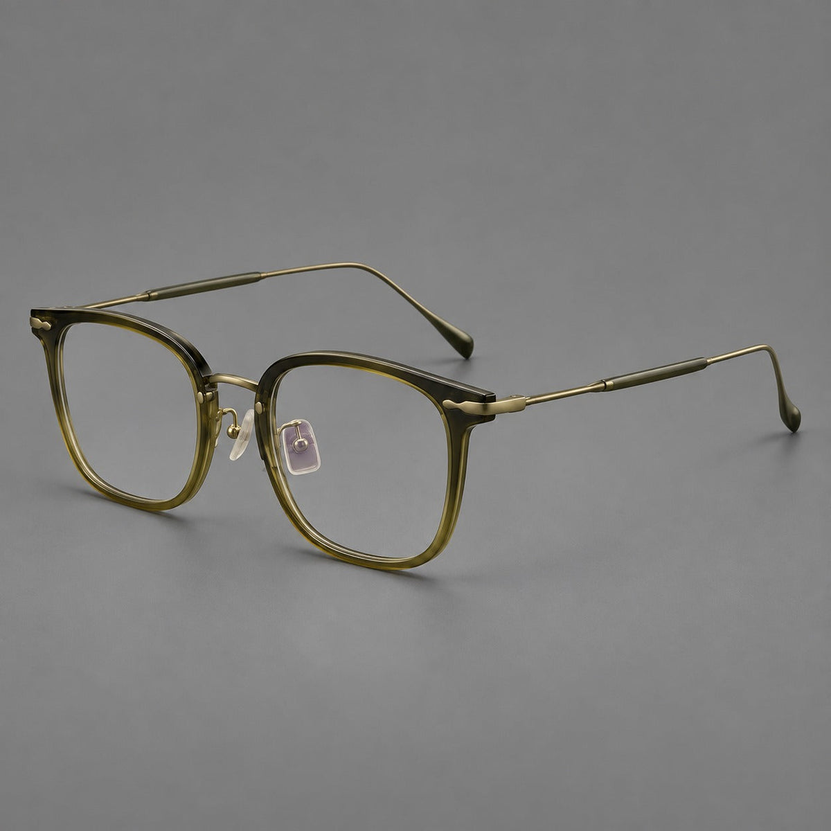 Retro square eyeglasses in acetate and titanium with rounded edges and sculpted corner accents in Green / Antique Bronze, three quarter view