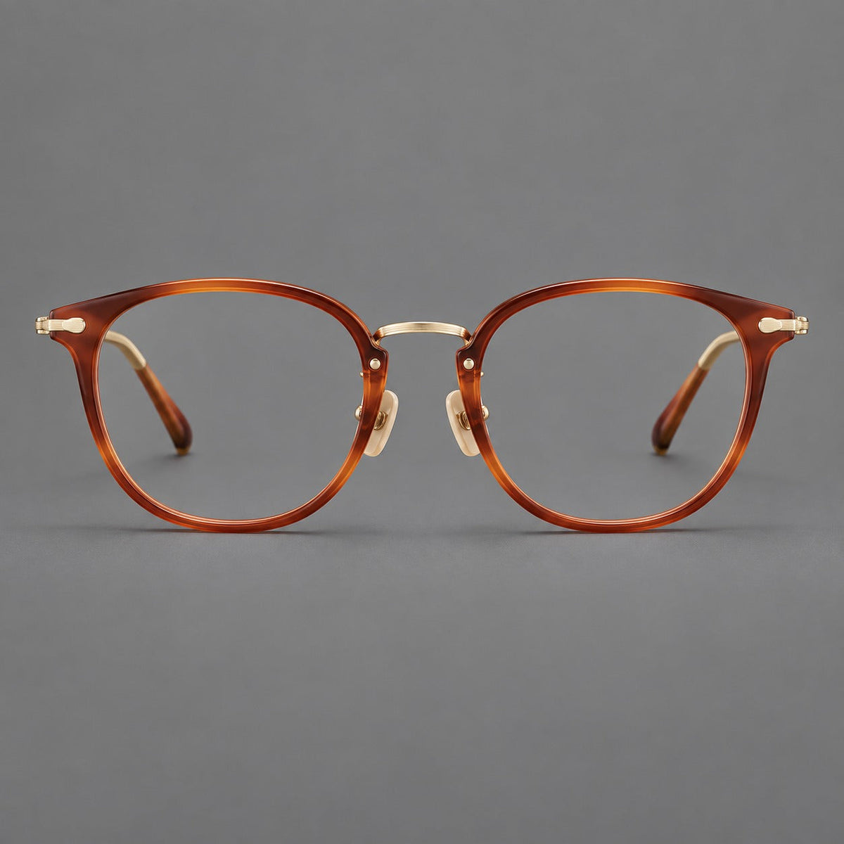 Classic soft square eyeglasses in acetate and titanium with engraved temples and corner accents in Amber Tortoiseshell / Gold, front view