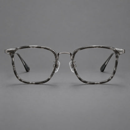 Soft square eyeglasses in acetate and titanium with wide upper corners and fine metal temples in Marbled Gray / Gunmetal, front view frame detail