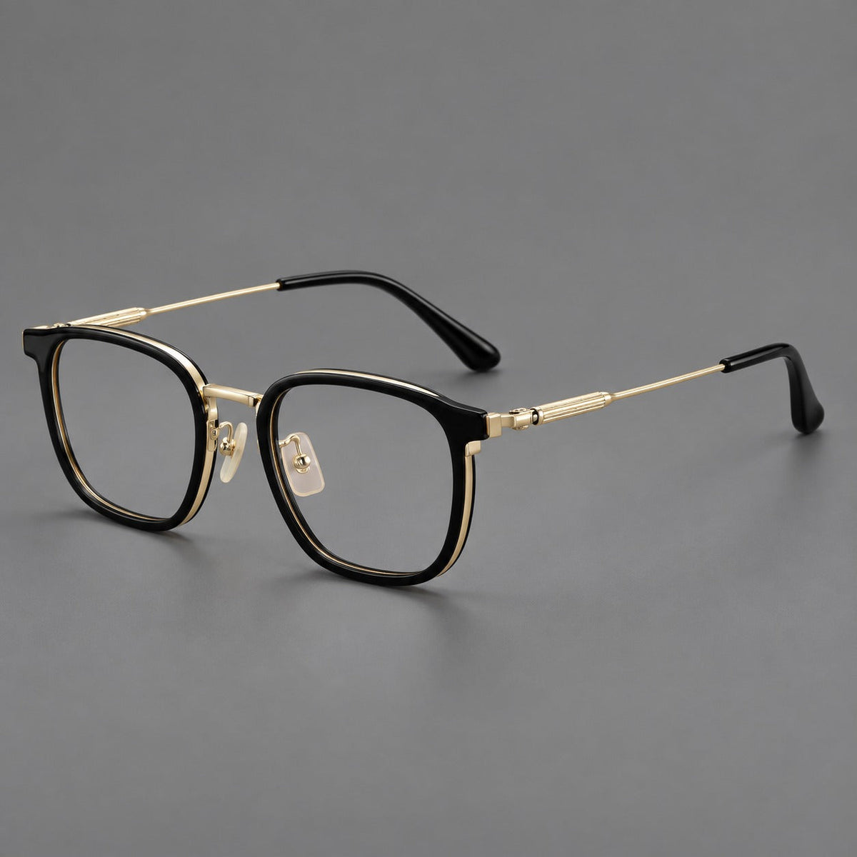 Soft square eyeglasses in acetate and titanium with wide upper corners and fine metal temples in Glossy Black / Gold, three quarter view