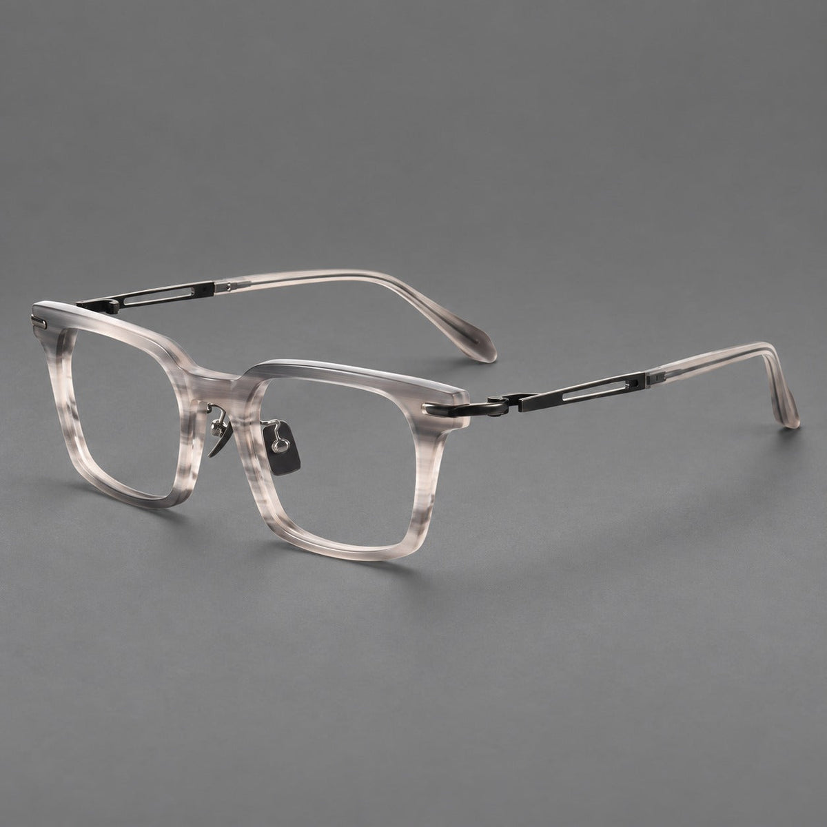 Modern acetate and titanium eyeglasses with angular square rims and curved metal hinges in Striped Gray / Brushed Gray, three quarter view