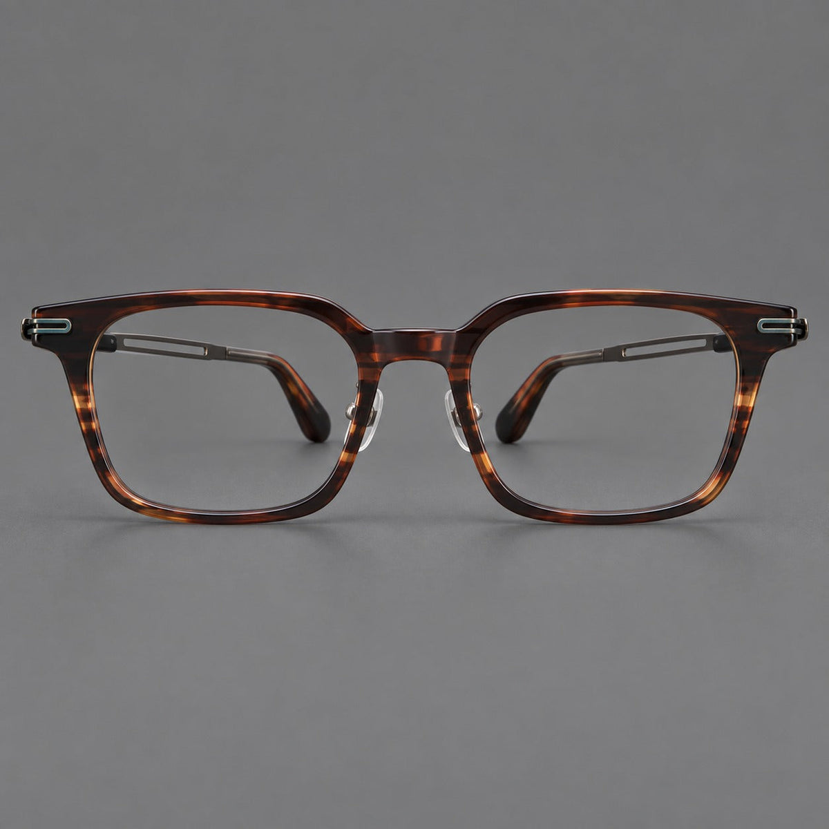 Modern acetate and titanium eyeglasses with angular square rims and curved metal hinges in Striped Brown / Antique Bronze, front view