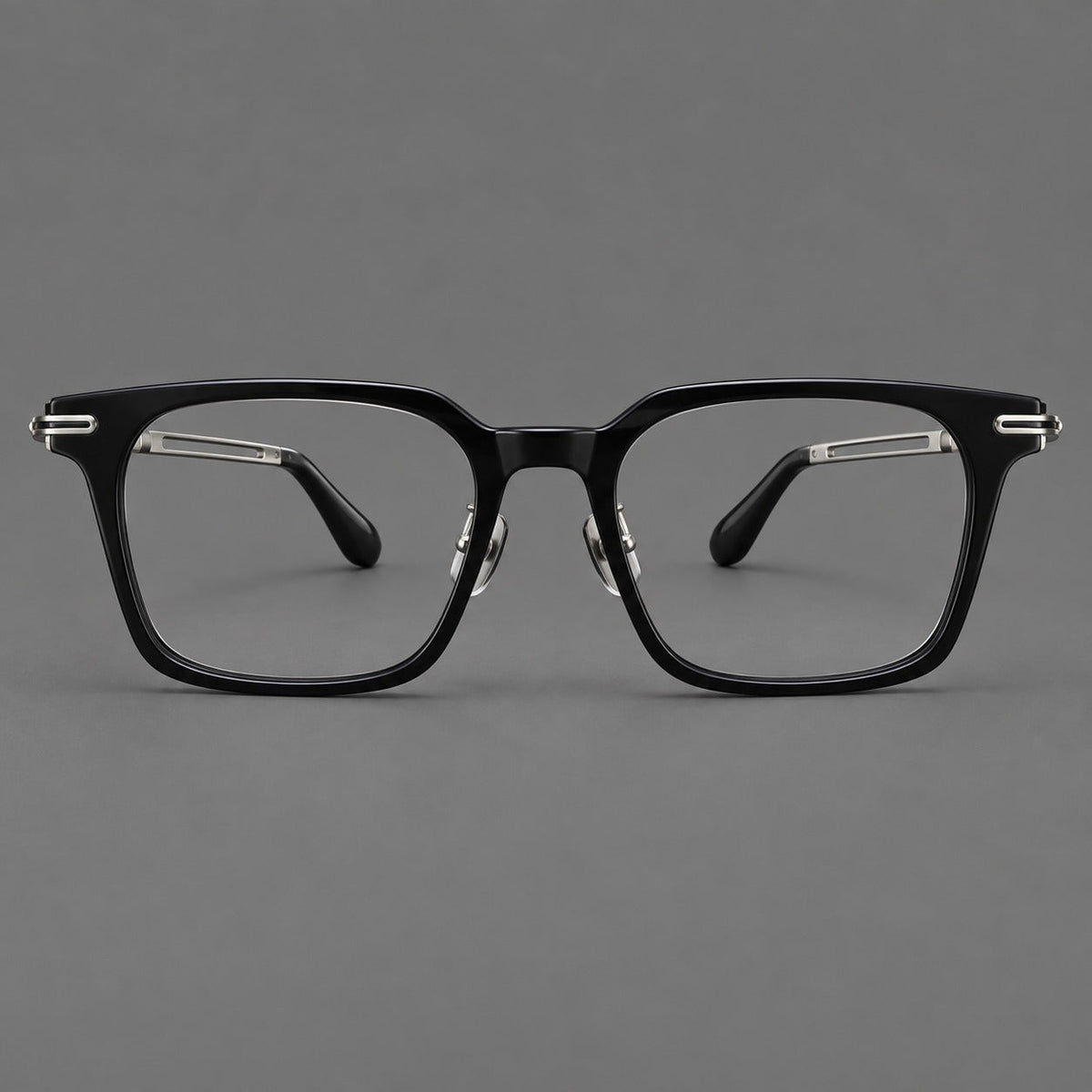 Modern acetate and titanium eyeglasses with angular square rims and curved metal hinges in Black / Silver, front view
