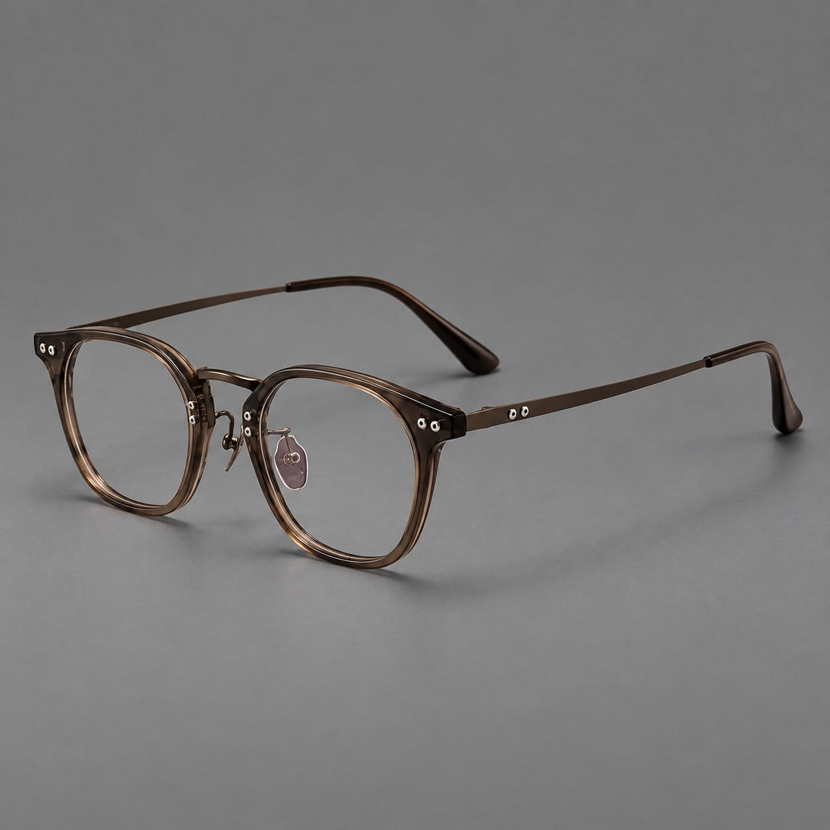 Retro acetate and titanium eyeglasses with softly rounded rims and a metal bridge in Coffee Brown, three quarter view