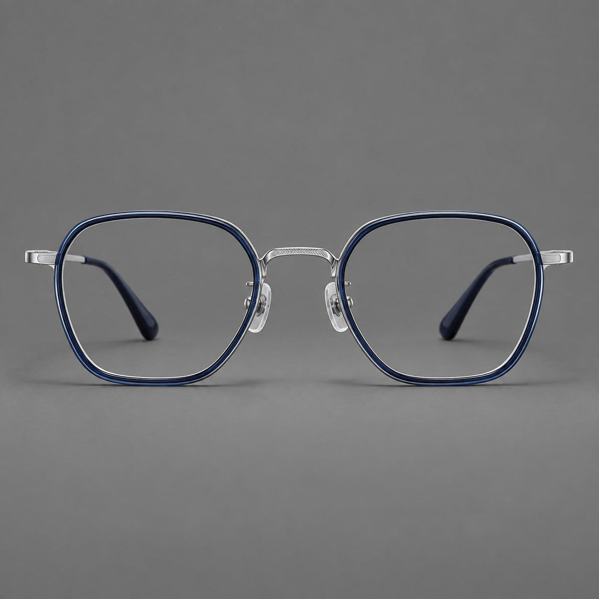 Soft square eyeglasses in acetate and titanium with slim rims and a finely engraved metal bridge in Blue / Silver, front view