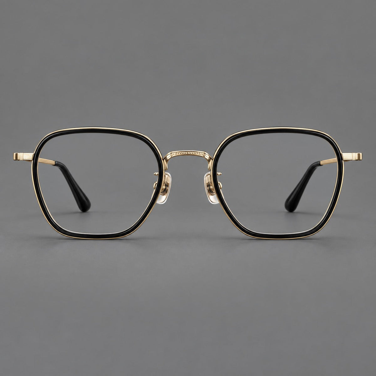 Soft square eyeglasses in acetate and titanium with slim rims and a finely engraved metal bridge in Glossy Black / Gold, front view