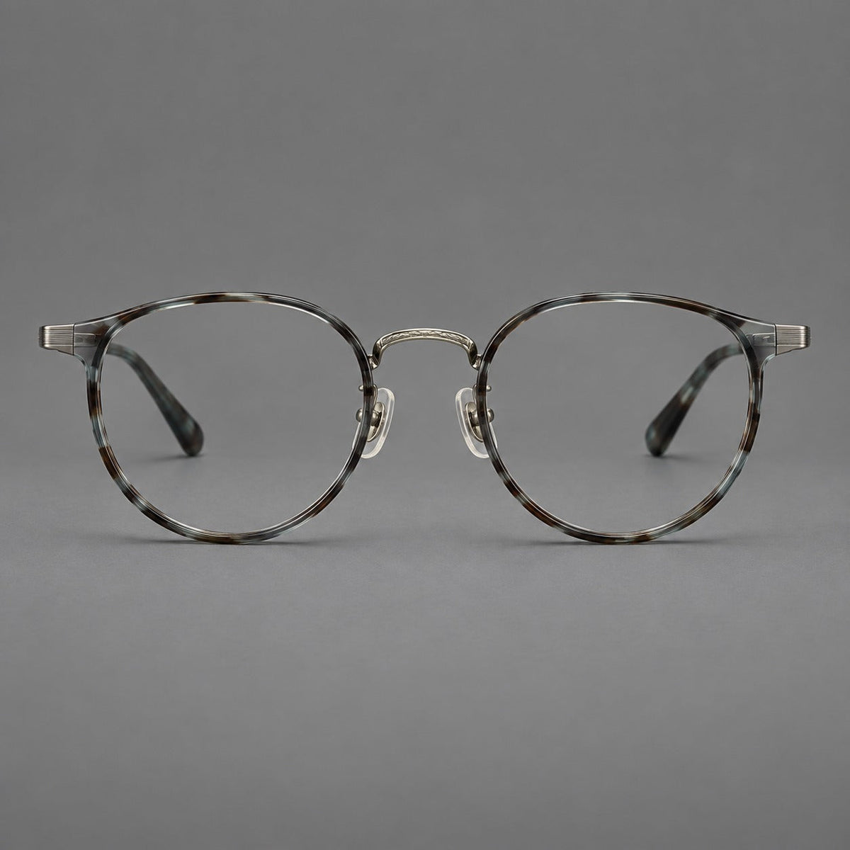 Round eyeglasses in acetate and titanium with widened outer corners and slender metal temples in Green Gray Tortoiseshell / Gunmetal, front view