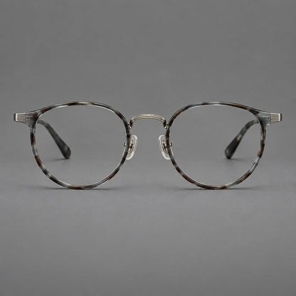 Round eyeglasses in acetate and titanium with widened outer corners and slender metal temples in Green Gray Tortoiseshell / Gunmetal, front view frame detail
