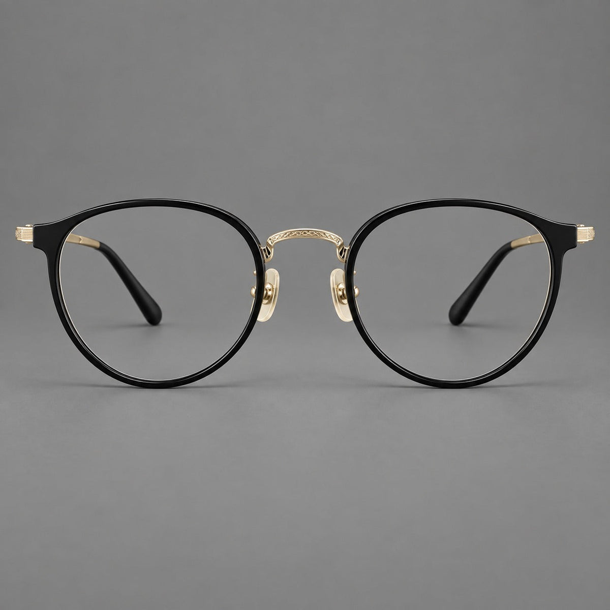 Round eyeglasses in acetate and titanium with widened outer corners and slender metal temples in Glossy Black / Gold, front view