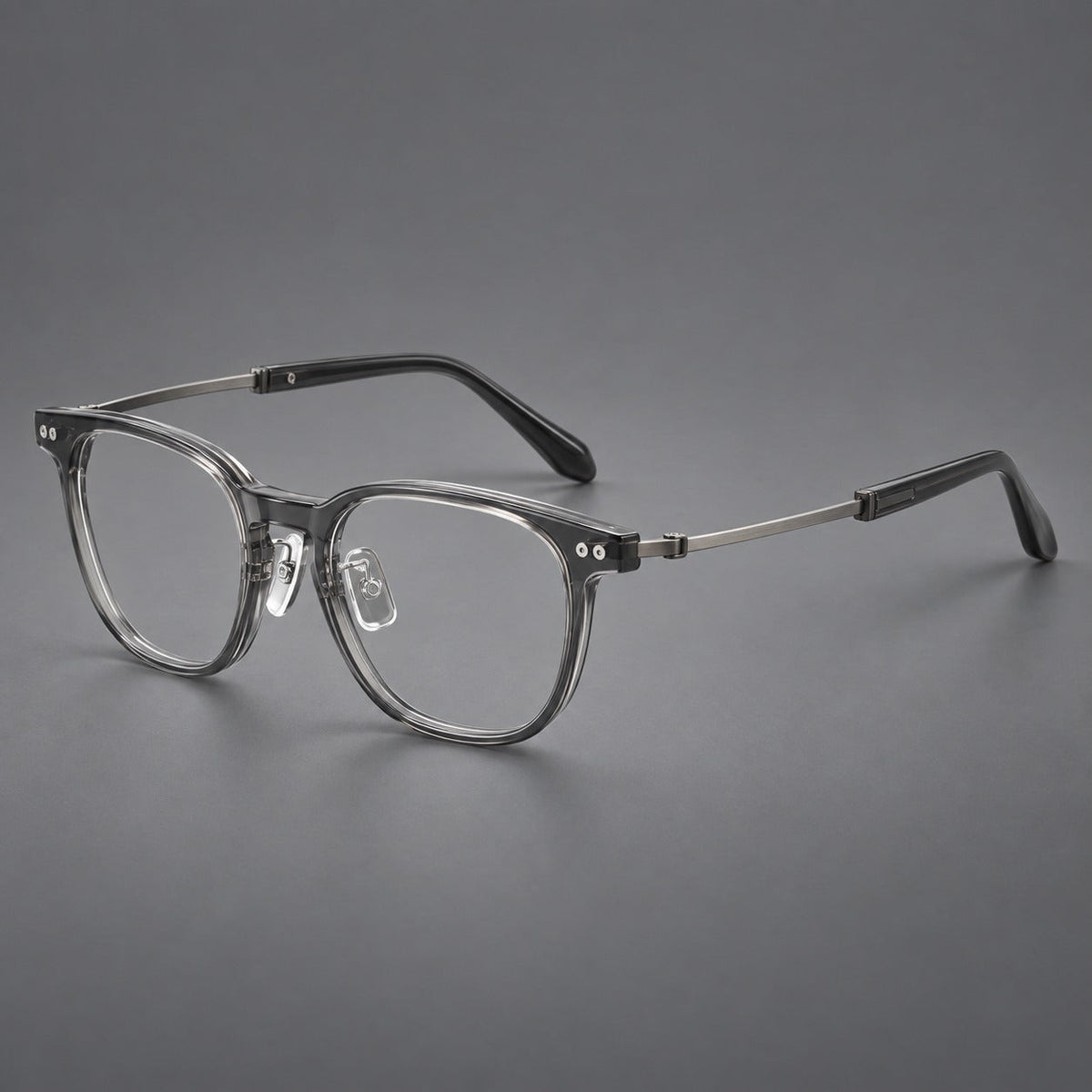 Vintage acetate and titanium eyeglasses with soft square rims and paired metal rivets in Clear Gray / Brushed Gray, three quarter view