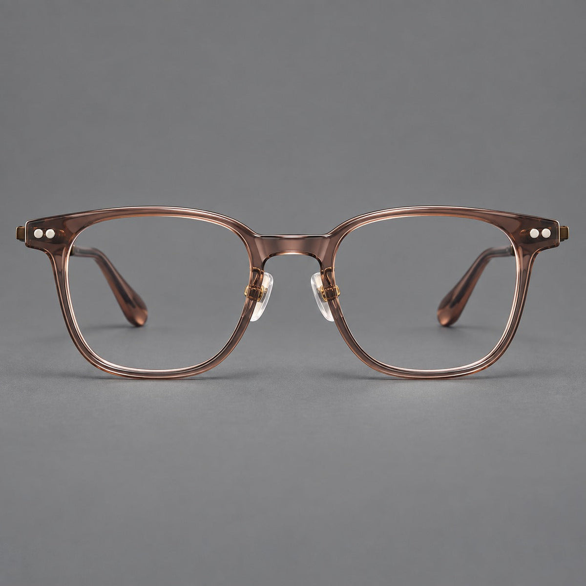 Vintage acetate and titanium eyeglasses with soft square rims and paired metal rivets in Clear Brown / Antique Bronze, front view