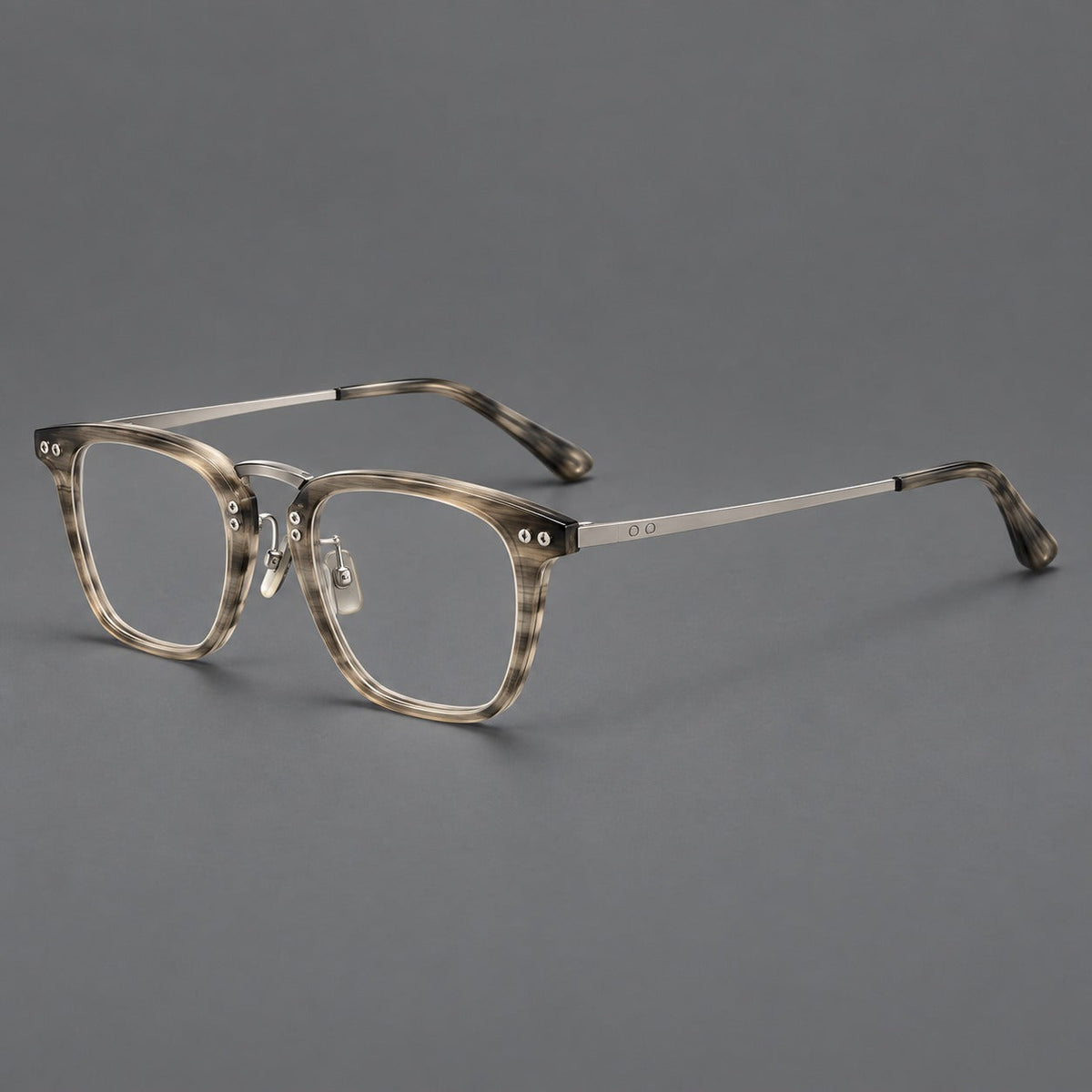 Acetate and titanium eyeglasses with soft square rims and an arched metal bridge in Gray Woodgrain / Silver, three quarter view