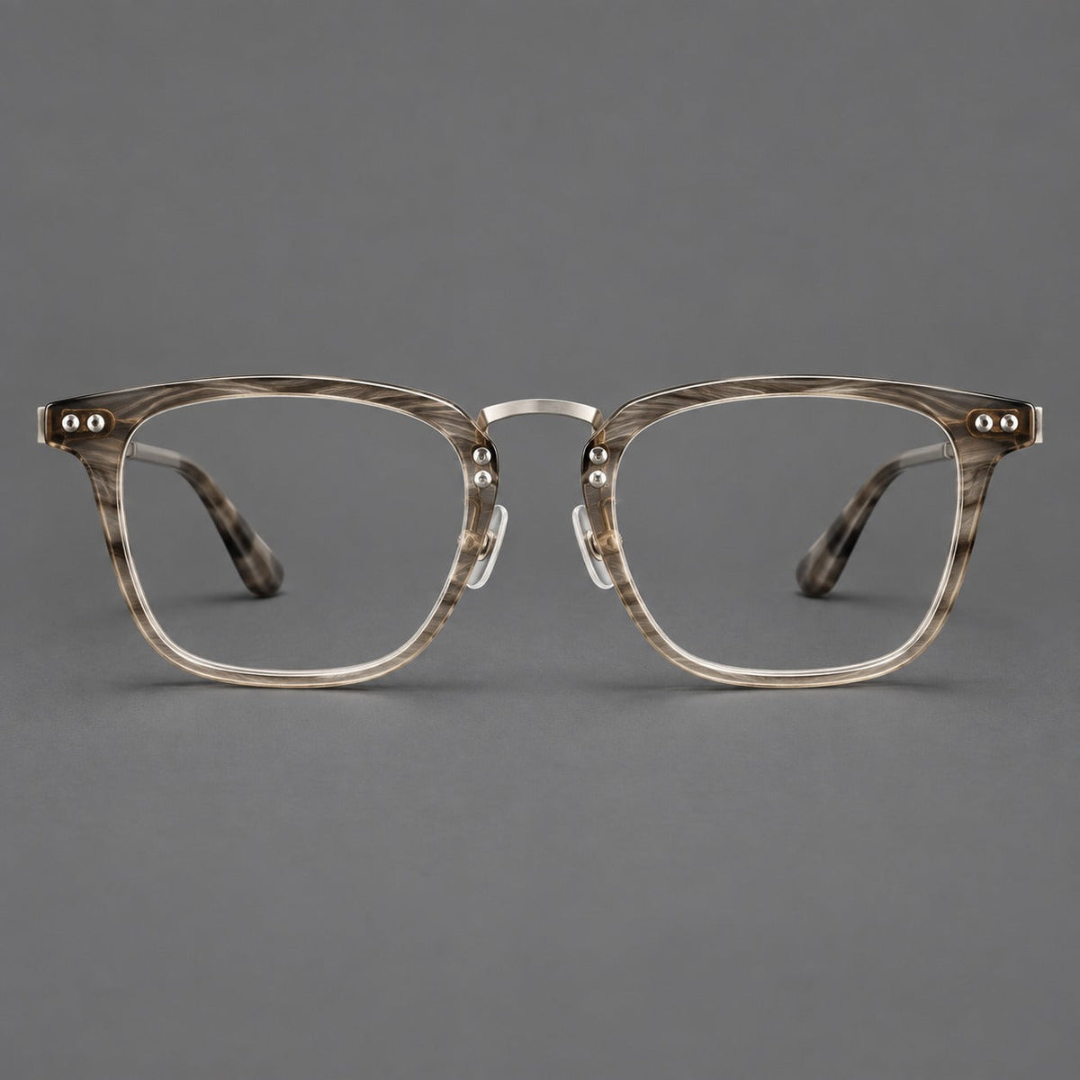 Acetate and titanium eyeglasses with soft square rims and an arched metal bridge in Gray Woodgrain / Silver, front view