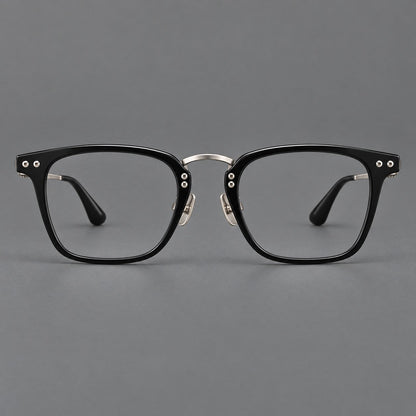Acetate and titanium eyeglasses with soft square rims and an arched metal bridge in Black / Silver, front view temple detail