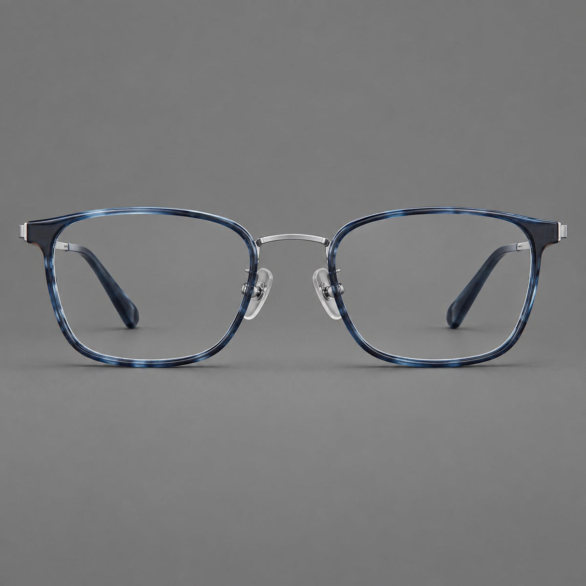 Rounded rectangular eyeglasses in acetate and titanium with bold corners and engraved metal temples in Blue / Gunmetal, front view