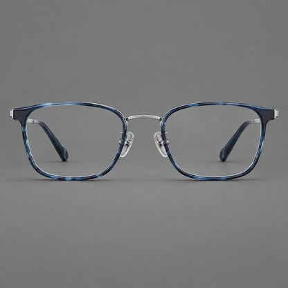 Rounded rectangular eyeglasses in acetate and titanium with bold corners and engraved metal temples in Blue / Gunmetal, front view frame detail