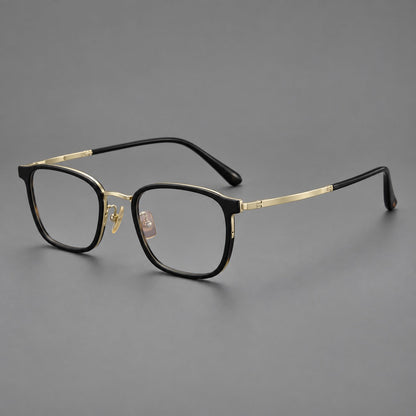 Rounded rectangular eyeglasses in acetate and titanium with bold corners and engraved metal temples in Glossy Black / Gold, three quarter view lens detail