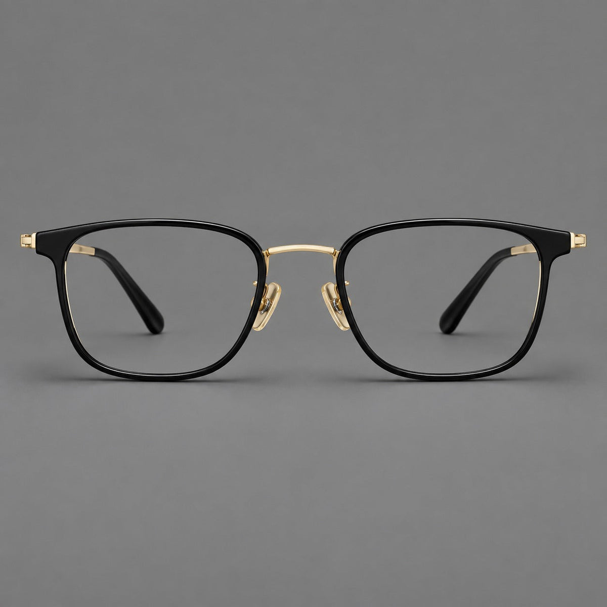 Rounded rectangular eyeglasses in acetate and titanium with bold corners and engraved metal temples in Glossy Black / Gold, front view