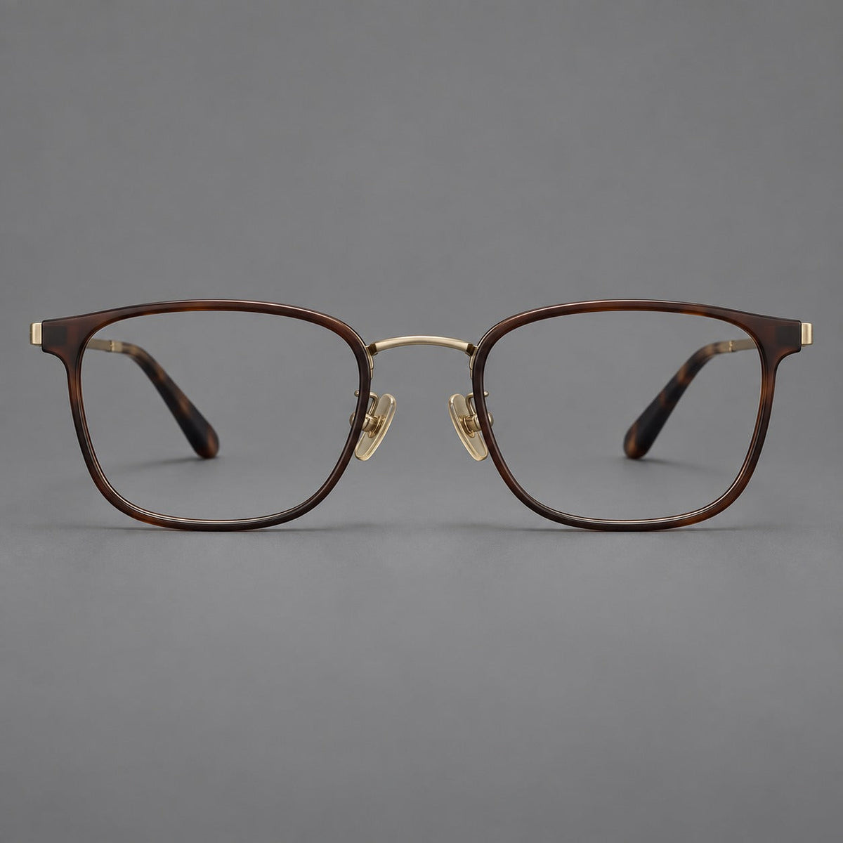 Rounded rectangular eyeglasses in acetate and titanium with bold corners and engraved metal temples in Coffee Brown / Antique Bronze, front view