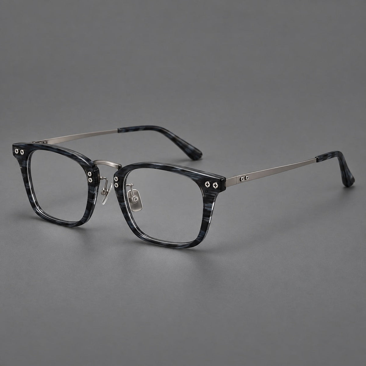Acetate and titanium eyeglasses with angular rectangular rims and a curved metal bridge in Gray Blue Woodgrain / Gunmetal, three quarter view