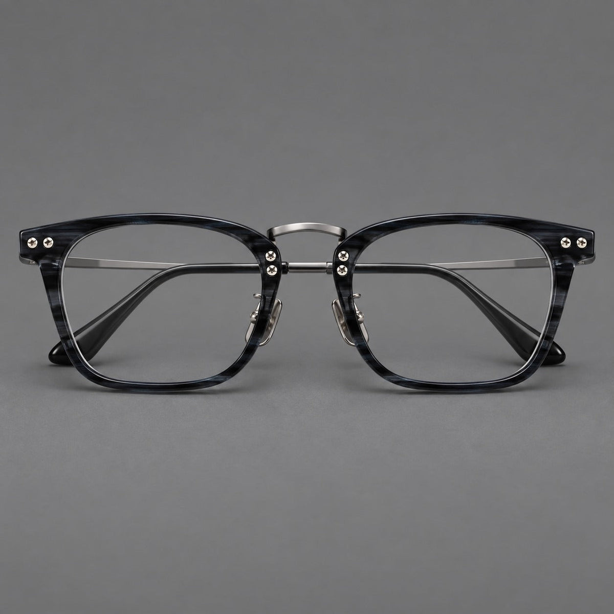 Acetate and titanium eyeglasses with angular rectangular rims and a curved metal bridge in Gray Blue Woodgrain / Gunmetal, front view