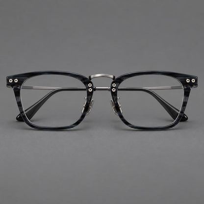 Acetate and titanium eyeglasses with angular rectangular rims and a curved metal bridge in Gray Blue Woodgrain / Gunmetal, front view frame detail