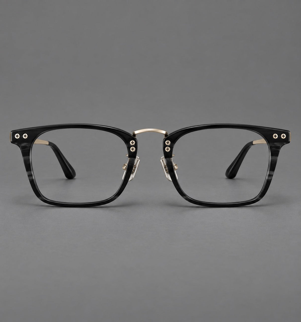 Acetate and titanium eyeglasses with angular rectangular rims and a curved metal bridge in Black / Gold, front view