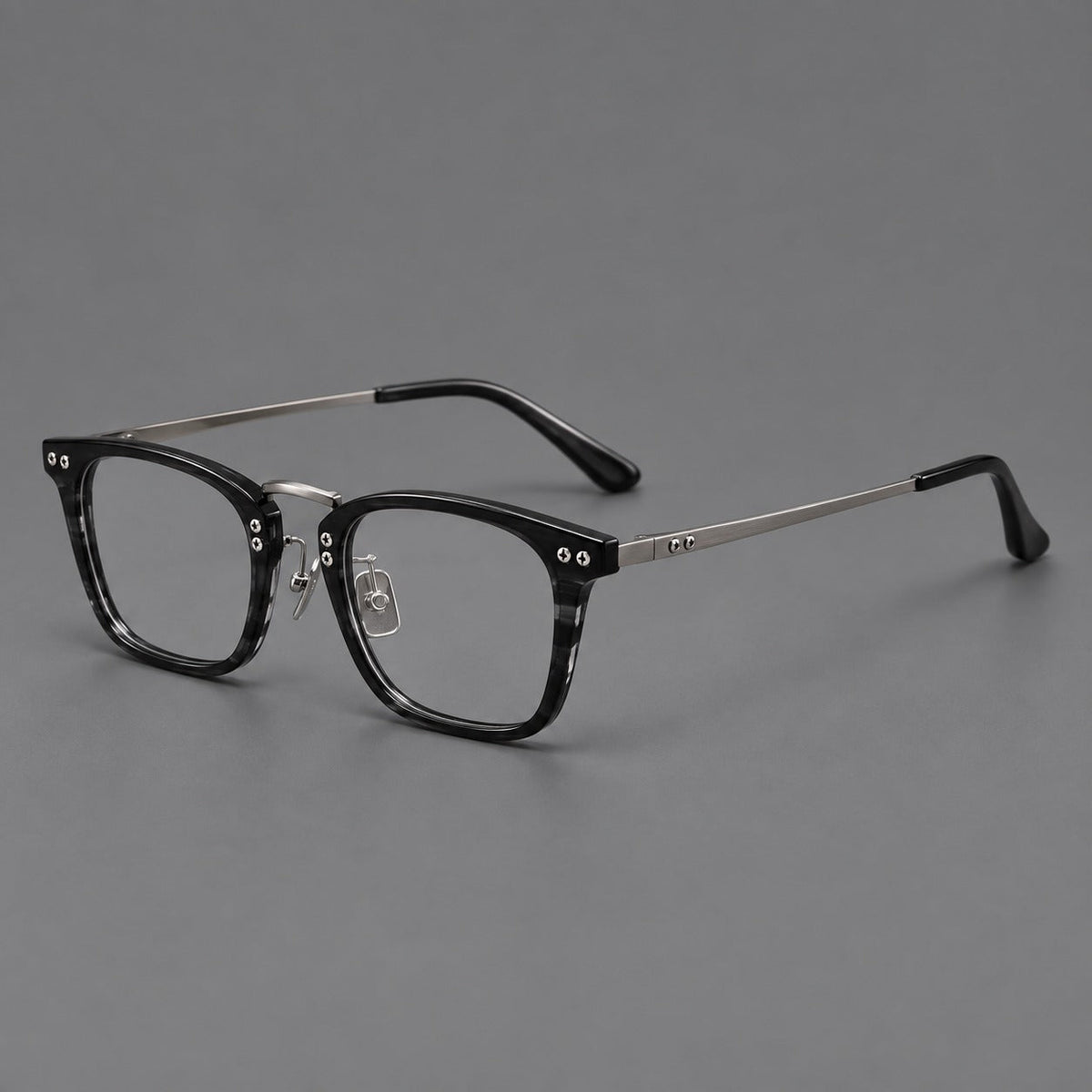 Acetate and titanium eyeglasses with angular rectangular rims and a curved metal bridge in Black / Gunmetal, three quarter view