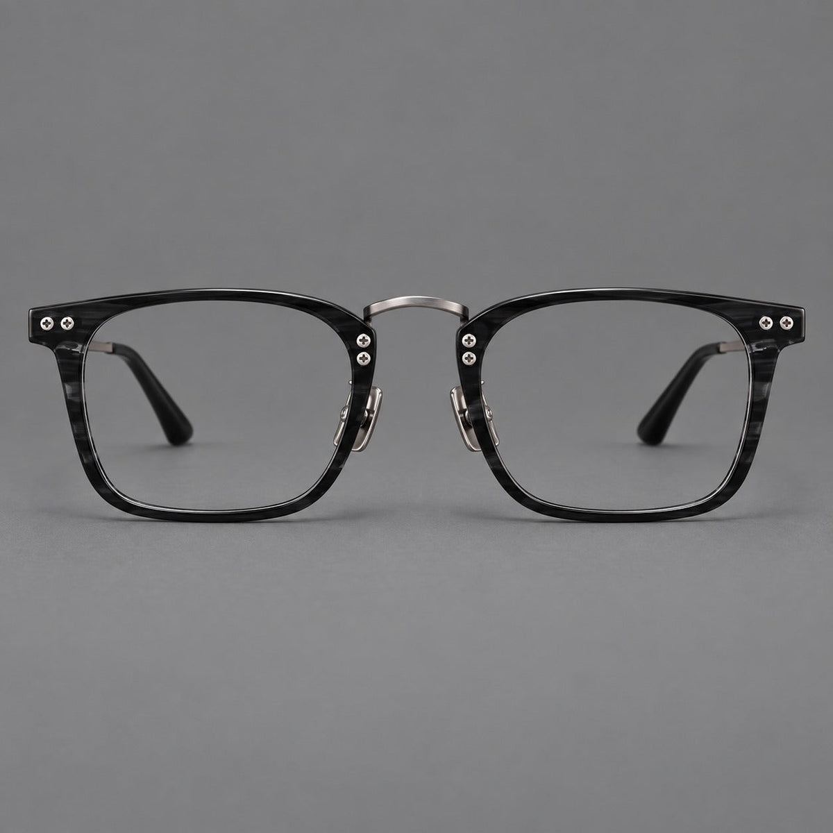 Acetate and titanium eyeglasses with angular rectangular rims and a curved metal bridge in Black / Gunmetal, front view