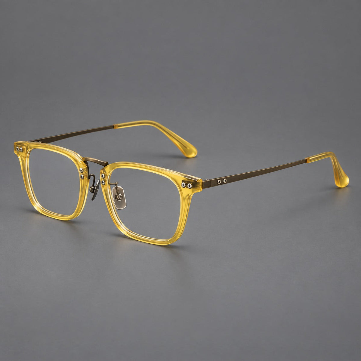 Acetate and titanium eyeglasses with angular rectangular rims and a curved metal bridge in Jade Yellow / Antique Bronze, three quarter view
