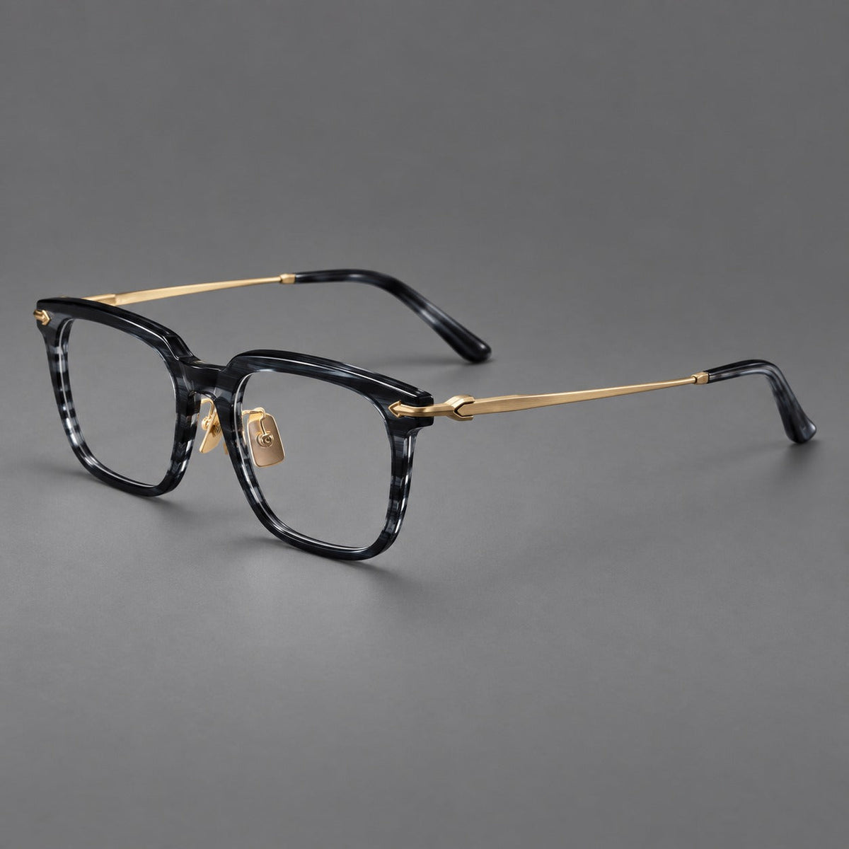 Bold acetate and titanium eyeglasses with rectangular rims and sculpted arrow accents in Gray Blue Woodgrain / Light Gold, three quarter view