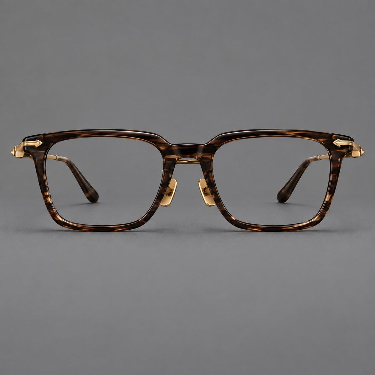 Bold acetate and titanium eyeglasses with rectangular rims and sculpted arrow accents in Tea Woodgrain / Antique Bronze, front view